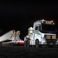 Oversize over mass vehicle at night loaded with super t girder